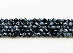 Macro detail view of faceted natural snowflake obsidian round beads for DIY jewelry