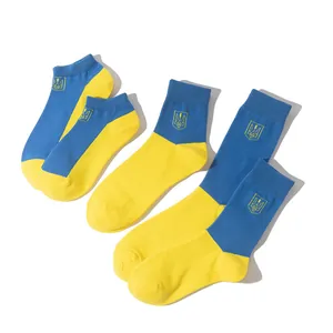Set of three cotton socks in blue and yellow Ukraine flag colors with emblem