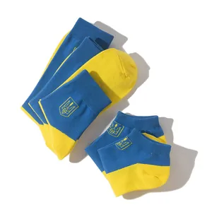 Close-up of Ukraine flag socks set showing blue-yellow block design and trident symbol