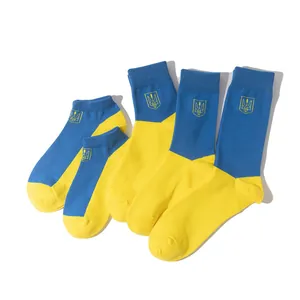 Detail view of blue and yellow Ukraine flag socks featuring trident embroidery