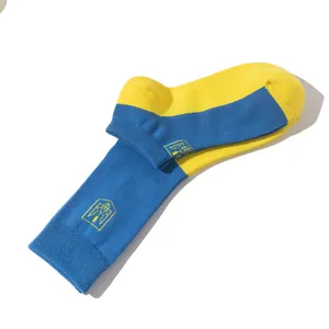 Macro view of blue and yellow bicolor socks featuring the Ukrainian trident coat of arms