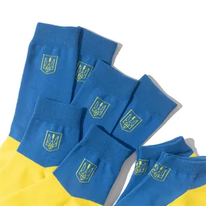 Close-up of blue and yellow cotton socks featuring the Ukraine national emblem.