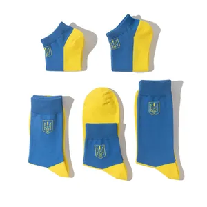 Detailed view of blue and yellow cotton socks featuring the Ukraine trident emblem