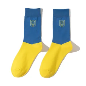 Detailed view of blue and yellow socks featuring the Ukrainian coat of arms trident