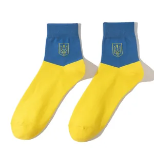 Detailed view of blue and yellow Ukraine flag socks featuring an embroidered Trident symbol