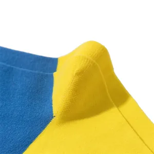 Macro close-up of Ukraine flag blue and yellow color-block cotton socks knitted texture