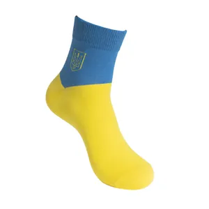 Close-up detail of Ukraine flag socks with embroidered yellow trident symbol on blue background
