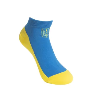 Close-up view of Ukraine flag socks with blue and yellow patchwork and national crest