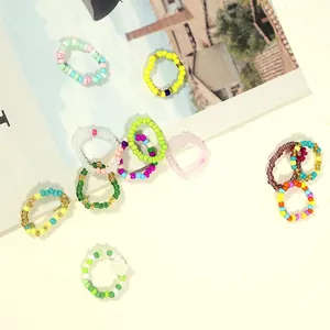Vibrant handcrafted seed bead rings in various colors, Hyuna style Bohemian jewelry set.