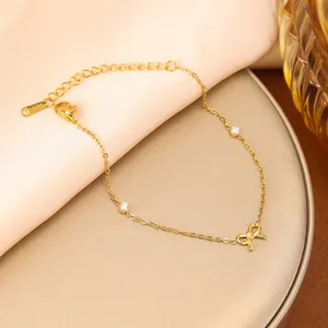 Close-up of this elegant gold bow bracelet featuring shimmering cubic zirconia stones.