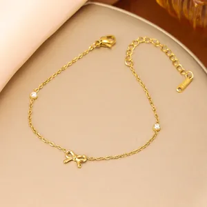 Close-up detail of a minimalist gold bow bracelet featuring cubic zirconia stones