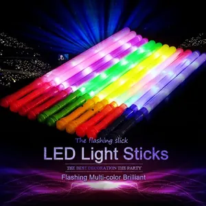 Vibrant multi-colored LED glow sticks lighting up a dark concert and party scene