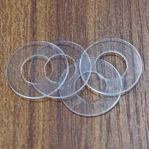 Close-up of laser-cut clear acrylic round discs with smooth edges and transparency