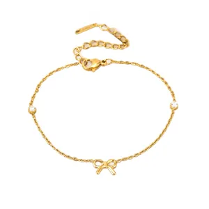 Elegant gold-toned chain bracelet featuring a dainty bow charm and clear stones.