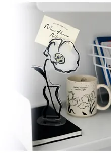 Close-up of a floral acrylic note holder with a 'Mini Flower' card on a desk