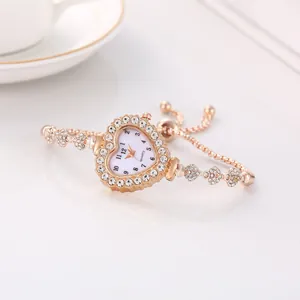 Dettaglio di un elegante orologio a forma di cuore in oro rosa con accenti in strass