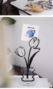 Acrylic tulip flower memo holder stand clipping a decorative planet card on a desk