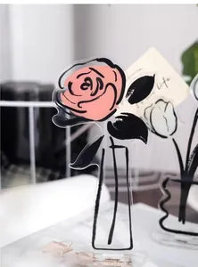 Detailed close-up view of a pink rose acrylic memo holder used as a decorative desk stand