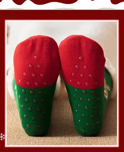 Macro view of non-slip silicone dots on Christmas theme thickened indoor floor socks.