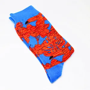 Vibrant blue cotton crew socks featuring bright orange tropical toucan and leaf patterns.