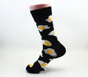 Detail shot of stylish black cotton crew socks featuring a vibrant fried egg pattern design.