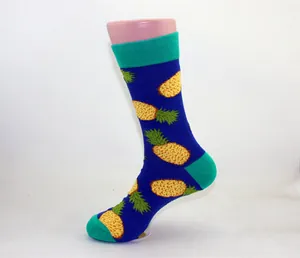 Blue mid-calf cotton sock with vibrant pineapple patterns displayed on a mannequin leg
