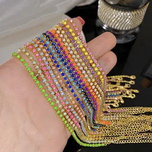 Close-up view of vibrant colorful imitation zircon crystal tennis necklaces held in hand