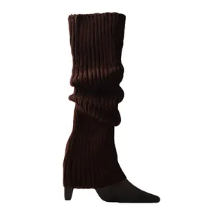Detailed view of dark brown knitted ribbed leg warmers showing soft pile texture