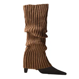 Close-up detail of soft brown rib-knitted leg warmers featuring a stylish slouchy texture