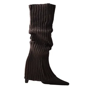 Close-up of dark brown ribbed knit leg warmers showing thick textured material details
