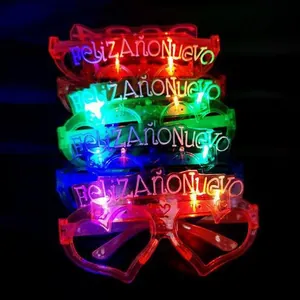 Close-up of LED glowing glasses with Feliz Año Nuevo Spanish text in colorful lights
