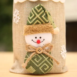 Primer plano de un muñeco de nieve decorativo en una bolsa de yute para botellas de Navidad