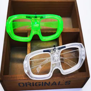Close-up of neon green and clear LED square shutter glasses in a rustic wooden display.