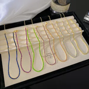Colorful crystal tennis necklaces displayed elegantly on a luxury velvet jewelry tray.