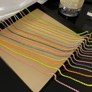 Detailed close-up showing multiple vibrant colorful tennis necklaces with sparkling crystals