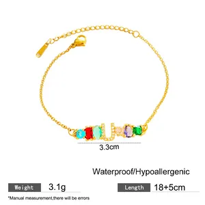 Pulsera dorada de gemas arcoíris con colgante de U, incluye peso y detalles de longitud.