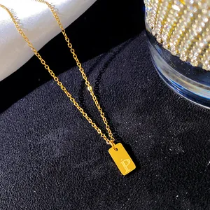 Gros plan d'un collier en acier inoxydable doré avec pendentif gravé lettre P