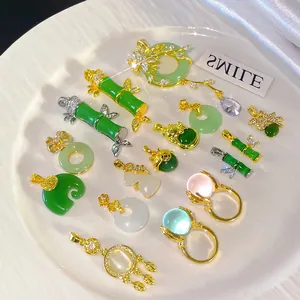 Detailed view showing a collection of faux jade pendants and rings with gold accents.