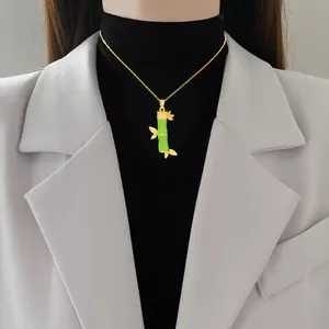 Dettaglio collana in oro con ciondolo a forma di bambù verde e cristalli lucenti.