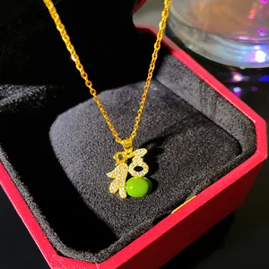 Elegant gold-toned necklace with 'Fu' character pendant and green faux jade bead