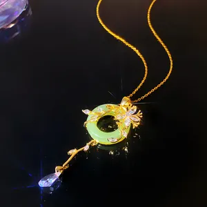Detailed macro view of a green jade-like donut pendant with gold floral crystal accents