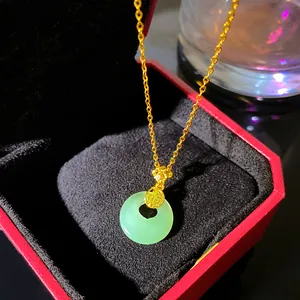 Detail view of Ping'an Kou jade-like pendant necklace with gold Fu character charm