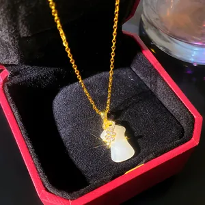 Detailed close-up of elegant Ruyi pendant necklace with white faux jade and gold chain