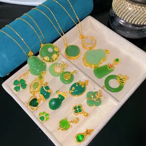 Detailed macro view of various green jade-style pendants in a jewelry tray display