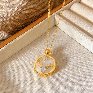 Detailed macro view of gold elk antler pendant necklace with cubic zirconia and flowers