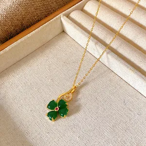 Detail shot of a New Chinese style four-leaf clover pendant necklace with green stones