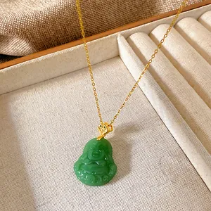 Close-up of a green Buddha pendant necklace with a gold-tone titanium steel chain
