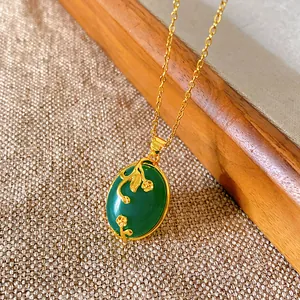 Close-up of a vintage Chinese style necklace featuring an elegant green oval pendant