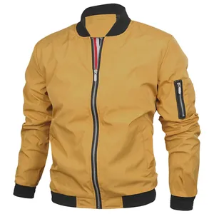 Detail of a yellow men's bomber jacket with black ribbed cuffs and utility sleeve pocket.