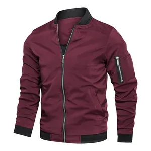 Detail view of a men's wine red bomber jacket with zipper pocket and ribbed trim